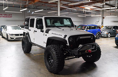 Alameda used car dealer with a white Jeep Rubicon for best used car deals.