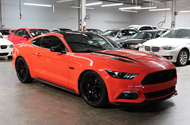 Red-Orange Ford Mustang for sale at our used car dealership near Alameda, California.